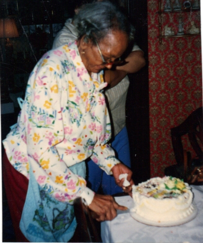 Mother cutting another one of her Birthday Cakes